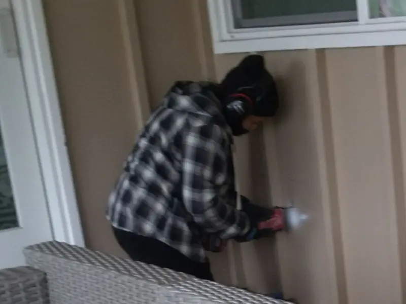 Professional electrician installing an exterior outlet in Sumner